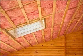 Fiberglass batts insulation installed in attic ceiling of Raleigh, NC home to prevent heat loss and improve year-round comfort