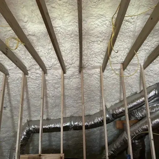 Attic in Raleigh insulated with open-cell spray foam for energy efficiency and moisture control