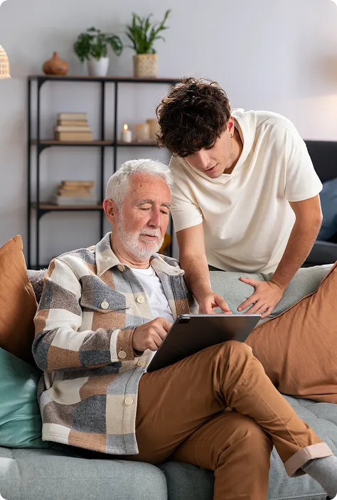 Older couple looking at a tablet with a healthcare agent