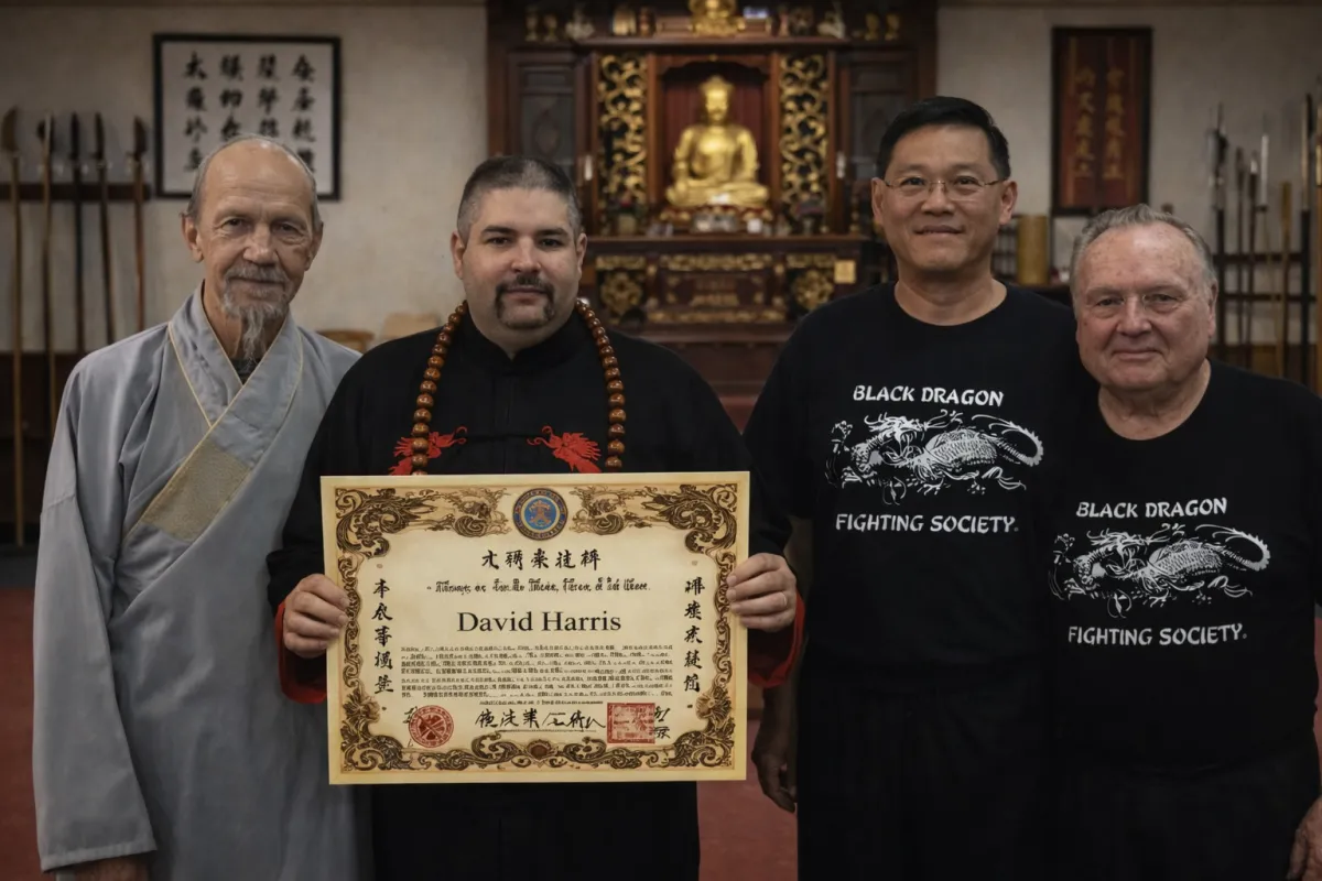 Grandmaster David Harris holding an official martial arts certification or rank document, standing with other senior masters in a traditional dojo with a Buddha altar.