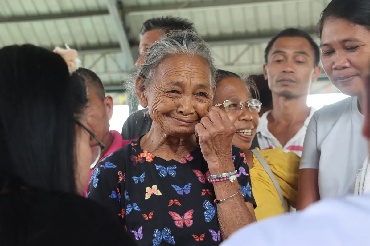 Documentary photograph of community volunteers conducting disaster preparedness and relief operations in a local village