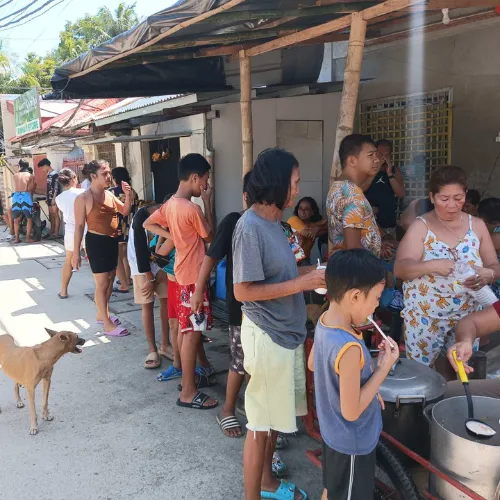 Volunteers organizing and distributing warm meals after a disaster
