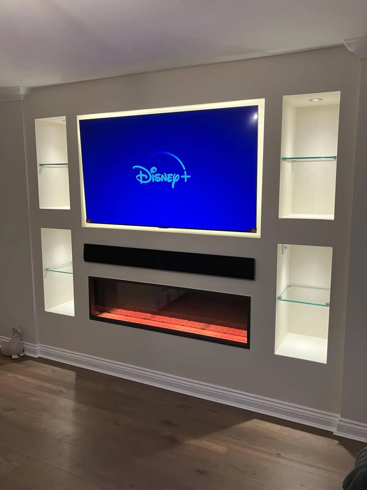 Plastered full wall media unit with illuminated glass alcove shelving - JAX Bespoke luxury design York