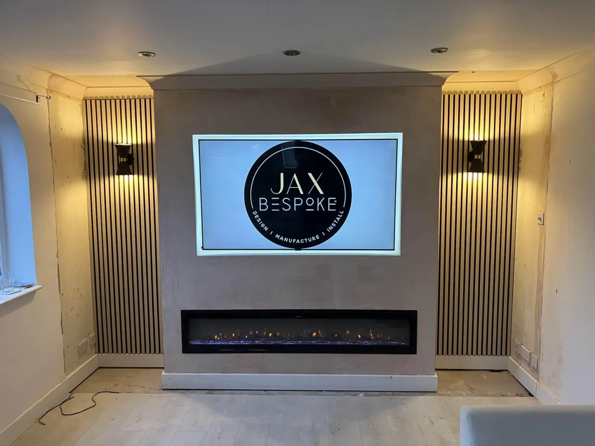 Modern media wall with wide electric fireplace and mounted TV, featuring acoustic wood paneling with integrated lighting