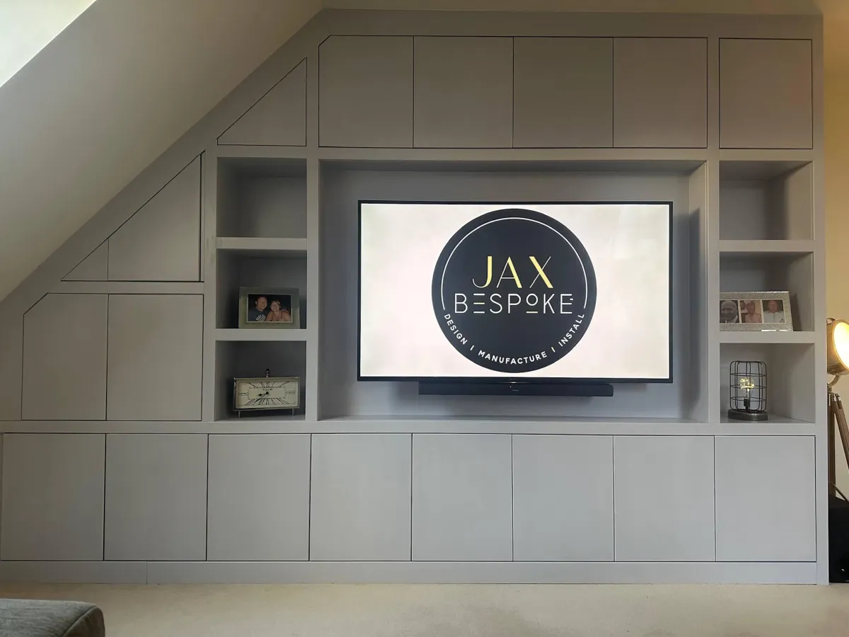 Bespoke grey media wall Yorkshire with sloping ceiling storage and display alcoves by JAX Bespoke
