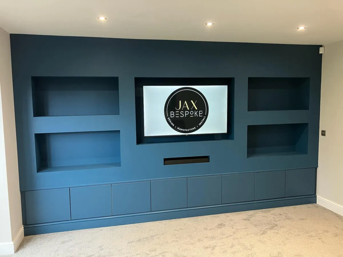 Dark Navy Blue Media Wall with integrated handleless cupboards for extra storage for a family home in Harrogate Yorkshire