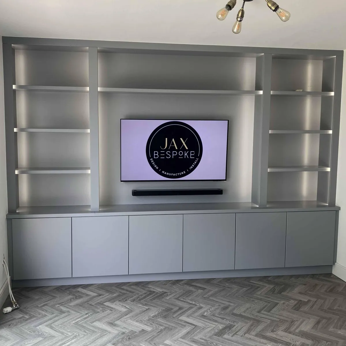 Modern grey media wall unit Yorkshire with built-in TV mount, soundbar recess and display shelving