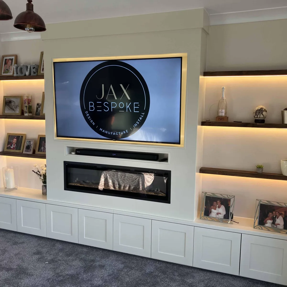 Luxury media wall Leeds with LED shelving, electric fireplace and custom storage unit by JAX Bespoke