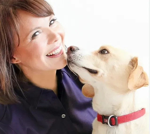 a woman and dog smiling