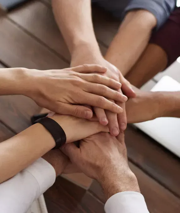 Team huddle symbolizing collaboration in mergers and acquisitions