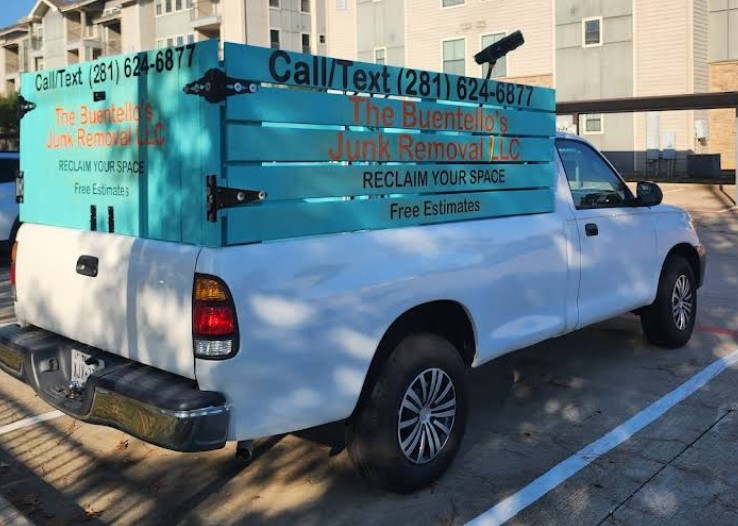 Wind turbine on a grassy hill at sunset