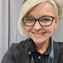 Melissa Kauffman, Clinical Manager at BioCore Clinic, smiling in a professional setting, emphasizing her dedication to empowering clients through personalized wellness programs.