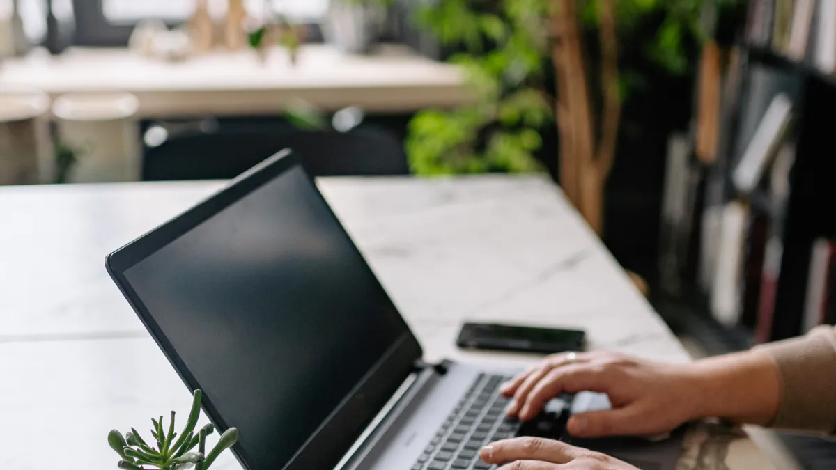 Clean modern desk with open notebook and laptop for publishing planning