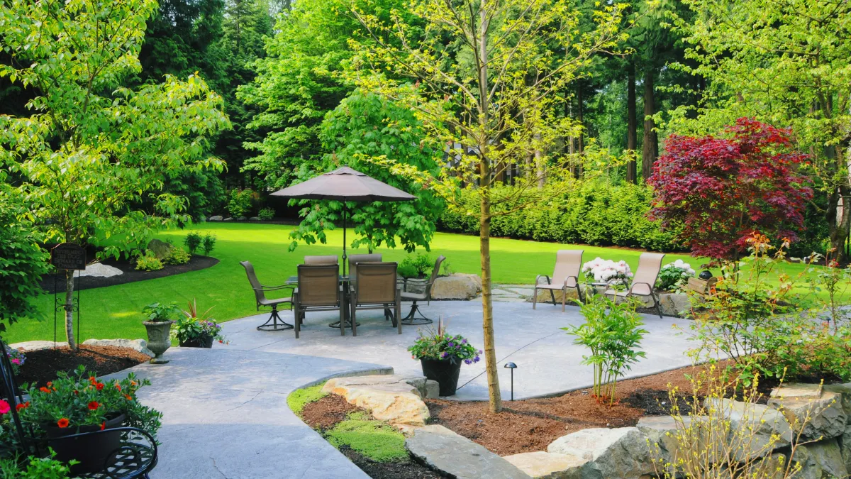 Beautiful backyard patio with seating and landscaping - Perfect Trim Lawn & Landscaping - landscape design services in Antioch