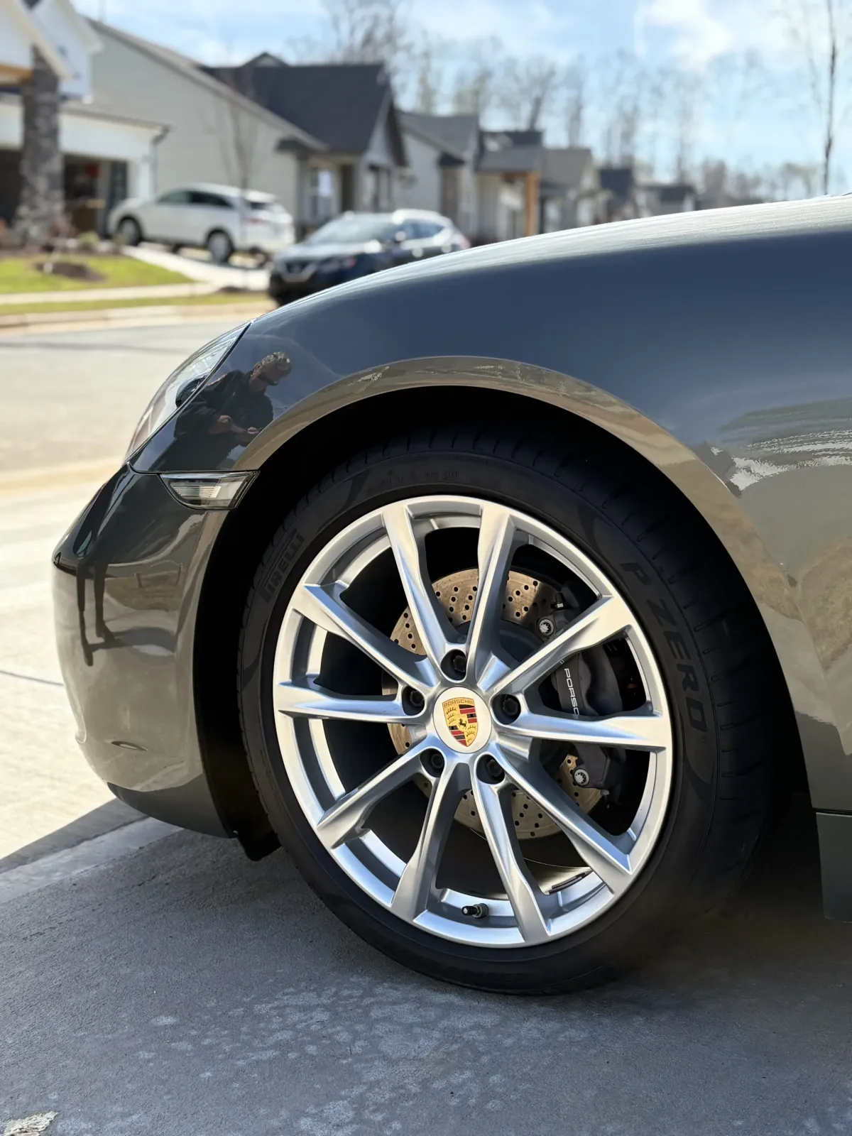 A black Porsche with clean rims and a glossy black exterior