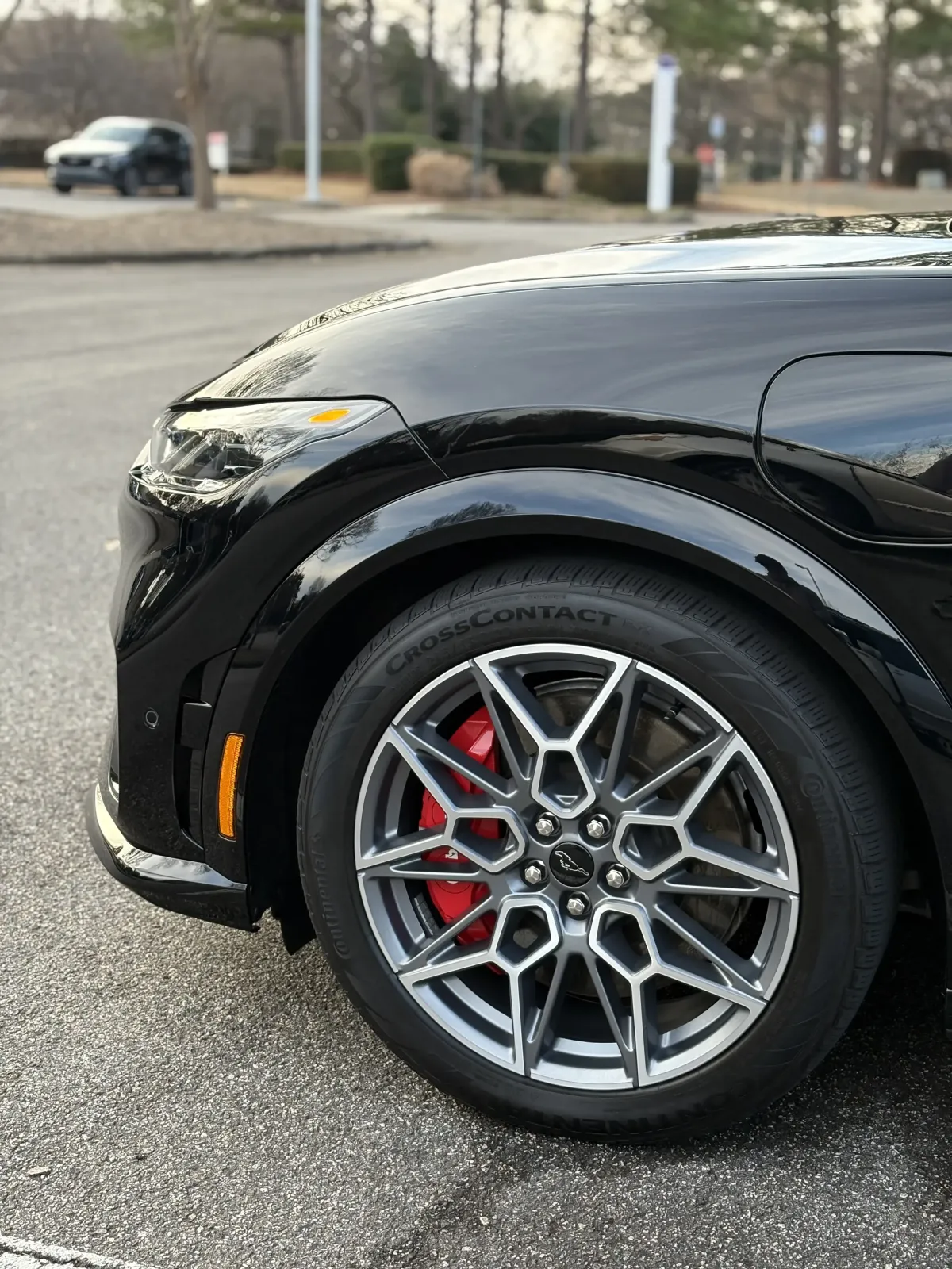 Closeup of a black sports car with a glossy finish and clean rims