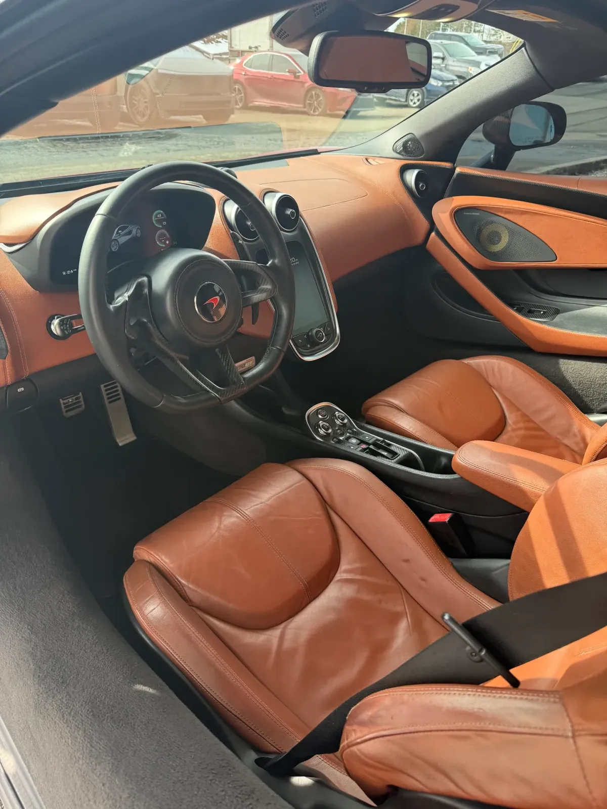 Interior of a recently detailed McLaren with clean seats, carpets and dashboard