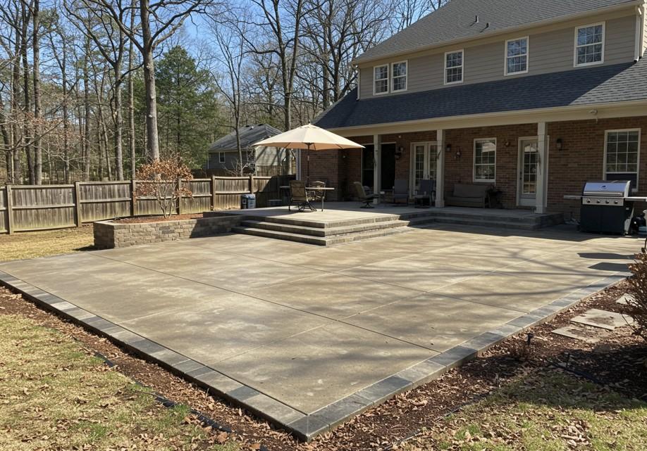 Smooth concrete patio installation in a backyard in Atlanta, ready for outdoor furniture or grilling
