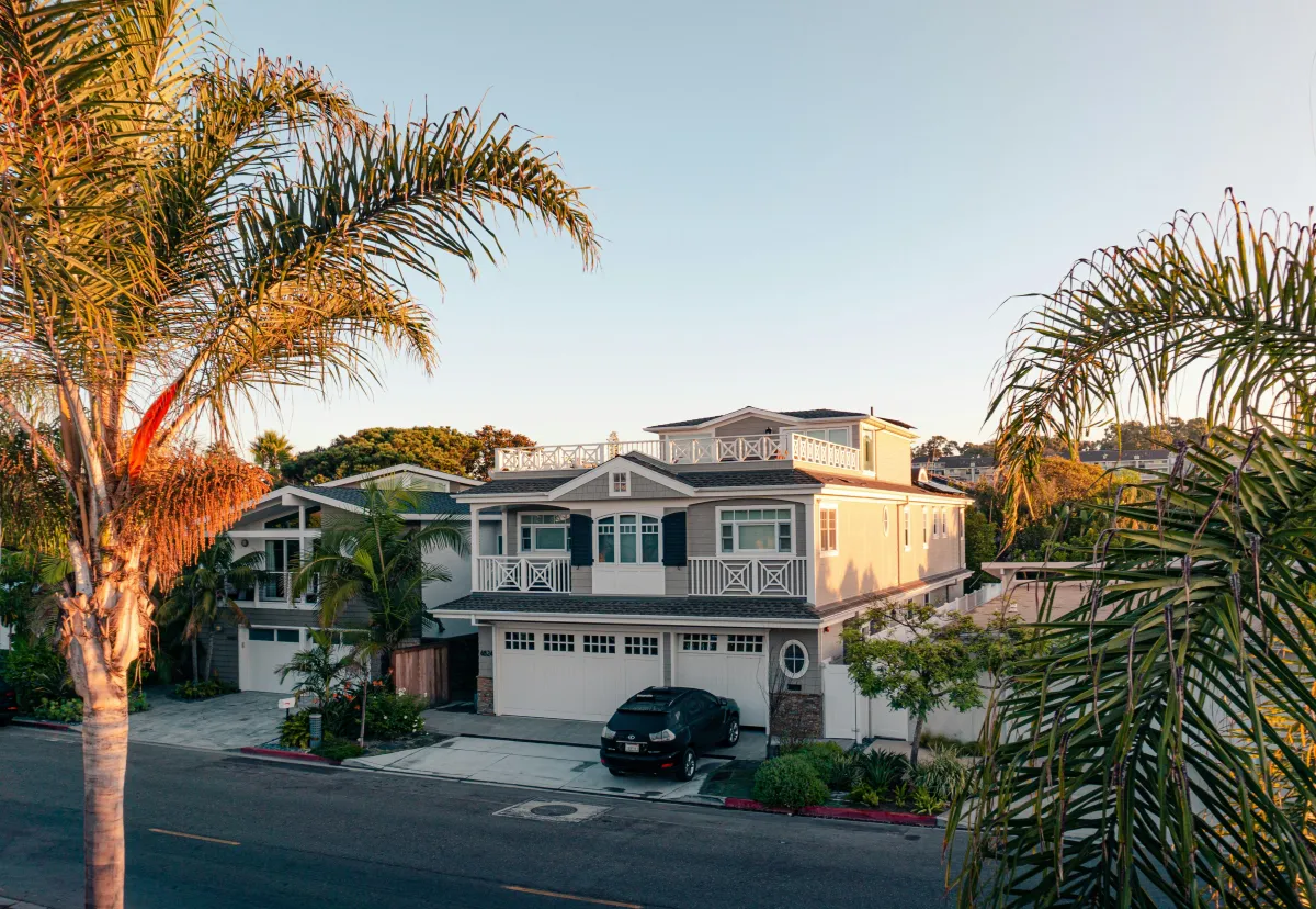 Southern California home with palm trees at sunset, for a guide to the monthly cost of a first home in Ventura County
