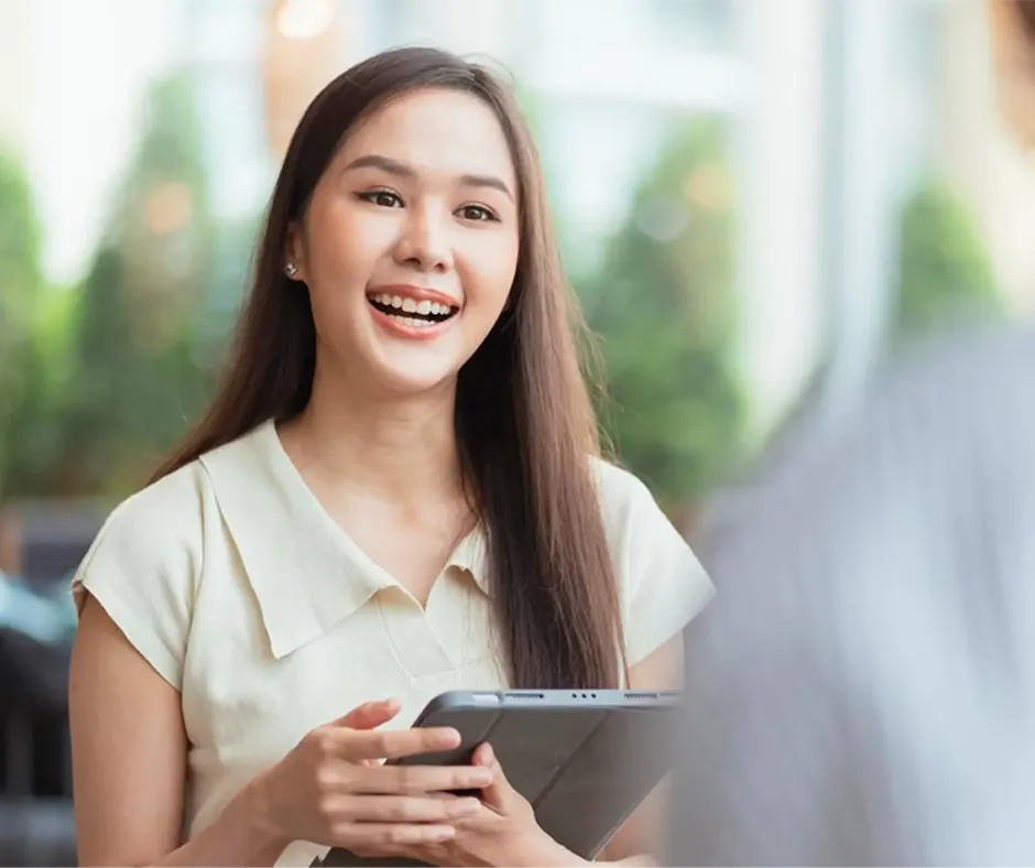 Clinic room detail with soft focused chair and green plant, bright calm light to suggest a safe therapeutic setting.