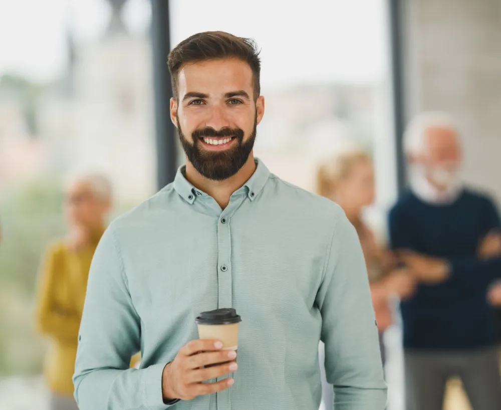 Happy salesperson with a coffee