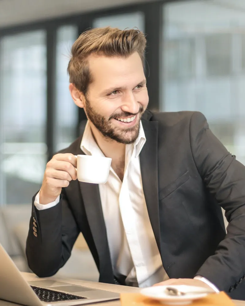 Happy salesperson with a coffee