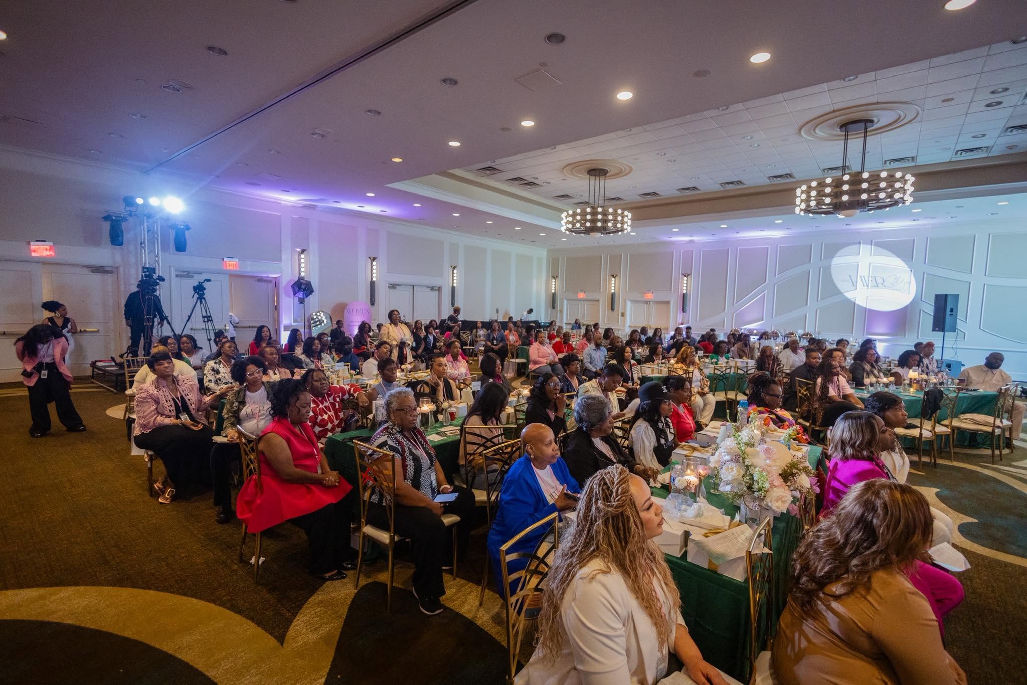 Women praying, laughing, and mentoring one another at an elegant event