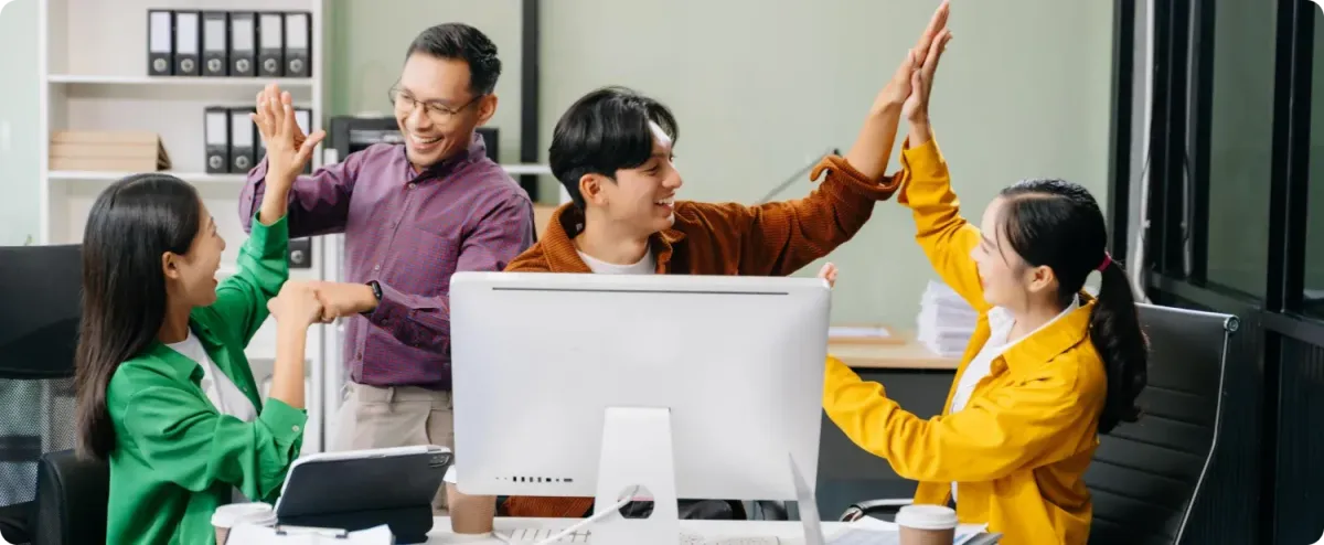 Digital marketing team celebrating successful SEO and lead generation results for small businesses