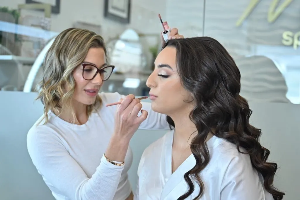 Wooden pier extending into calm ocean at sunset