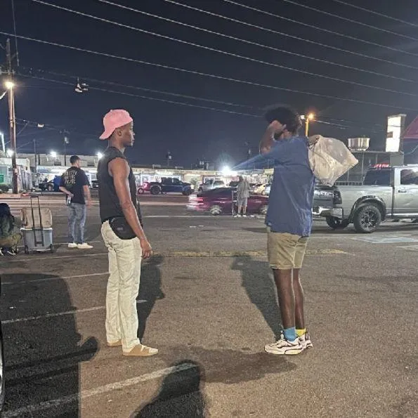 woman in black sweater holding white and black vr goggles