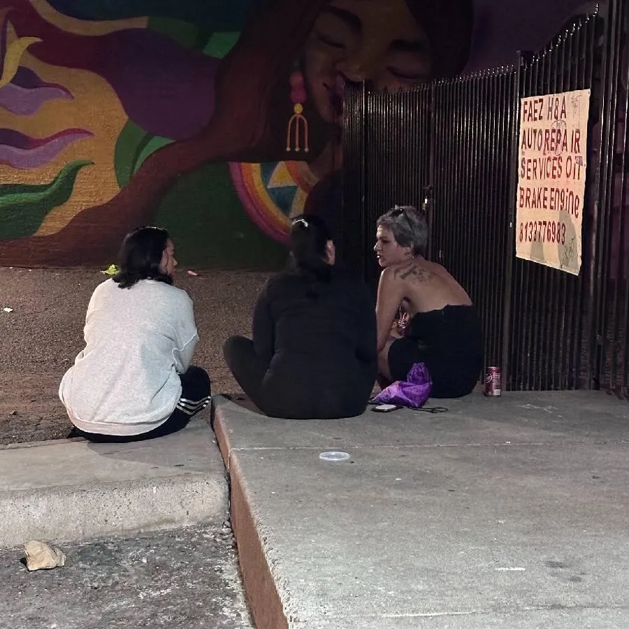 people sitting on ground while forming round during daytime