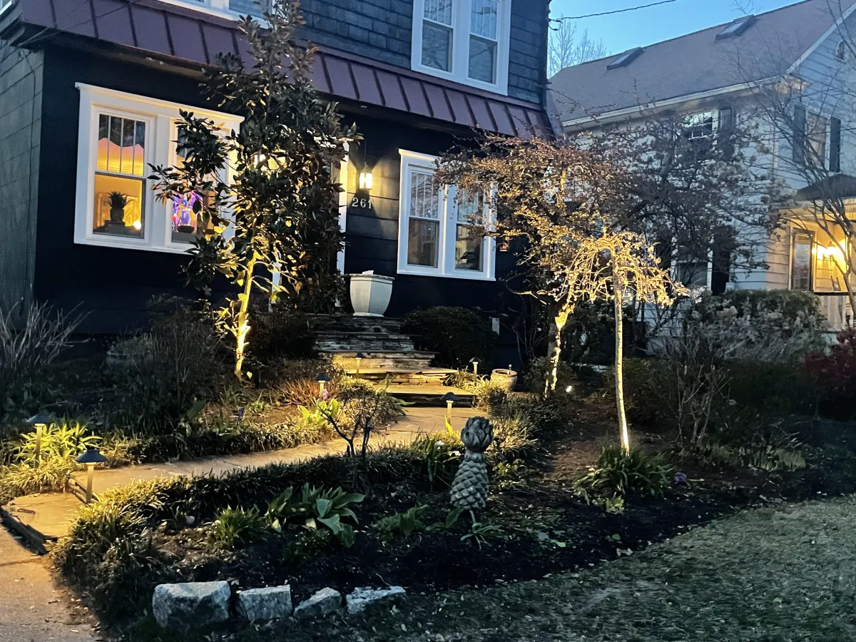Modern South Jersey backyard featuring a custom paver patio, inground swimming pool, landscape lighting, and outdoor living space designed to increase property value.