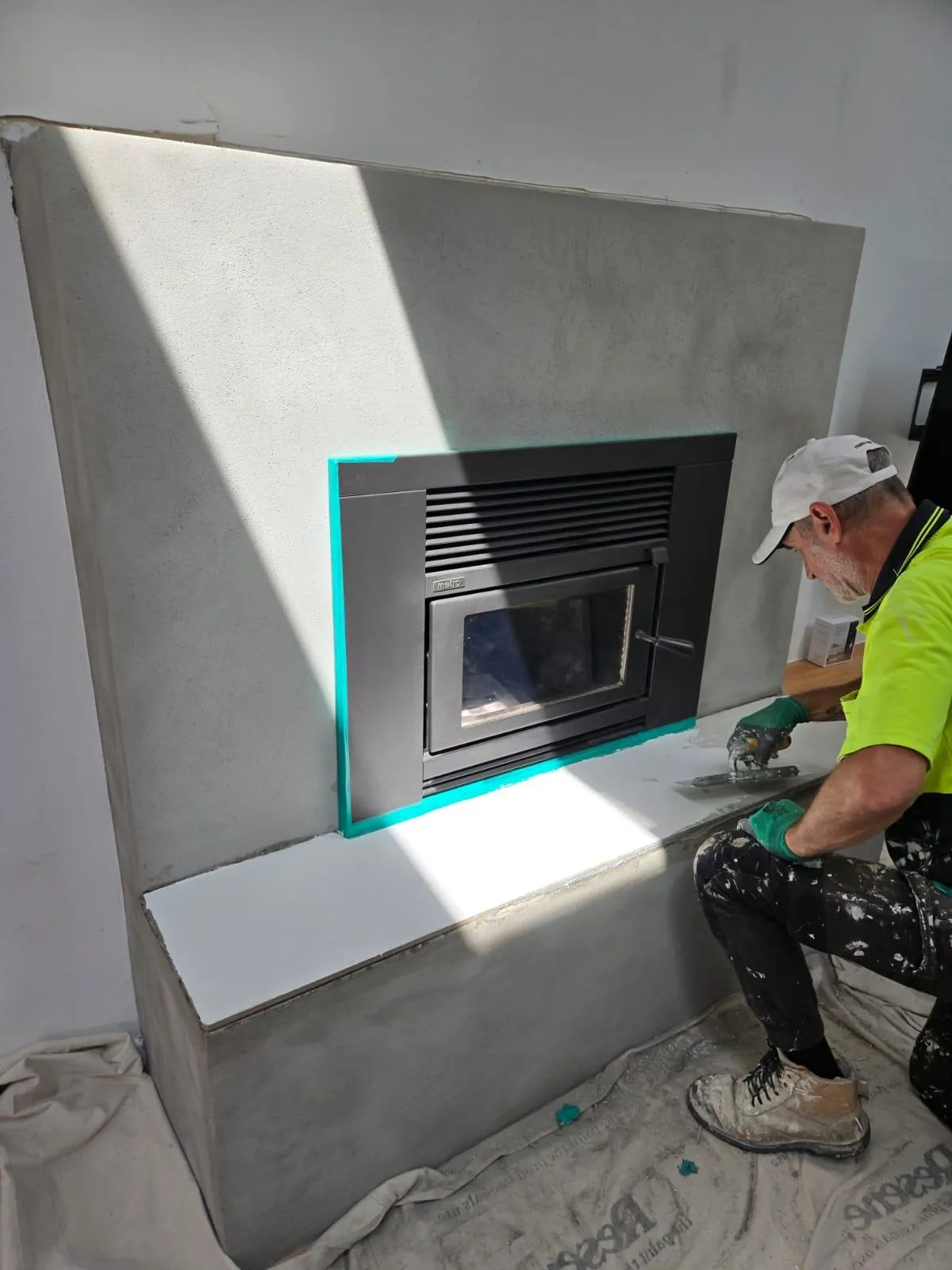 Applying venetian plaster around fireplace