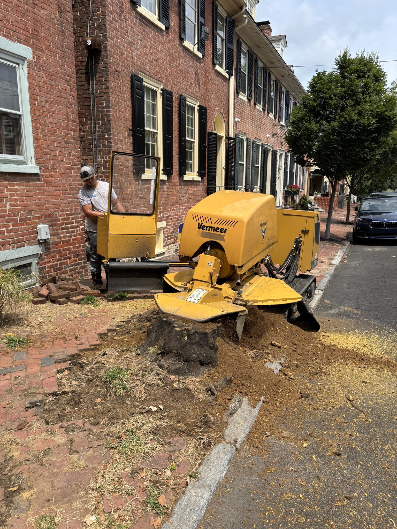 Cyclists riding down a wooded mountain trail.