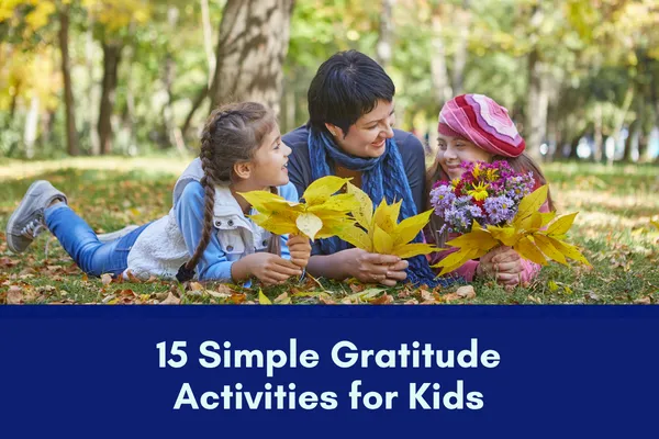A mother with two children laying on the ground outside, enjoying nature