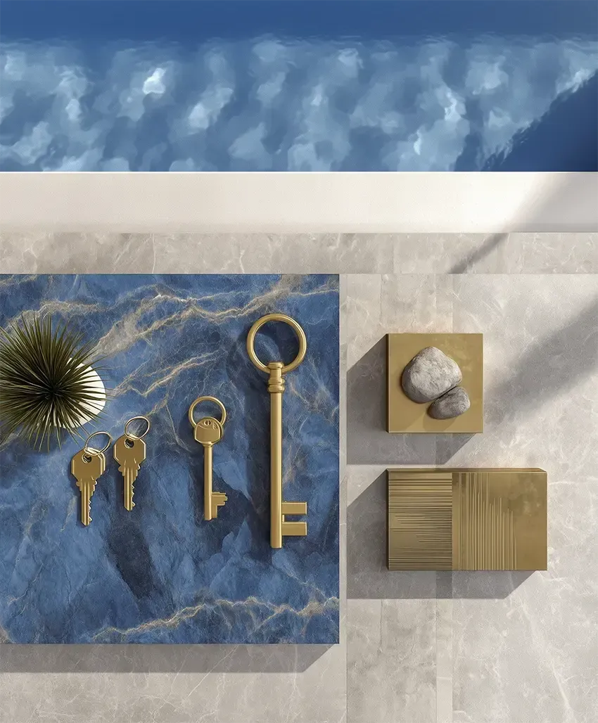 A top view of keys and home decor items placed on an outdoor poolside representing the "keys to the deal"