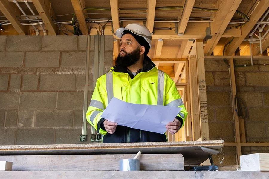 A client of Novus Marketing AI Cummin & Co. looking through plans for a construction project