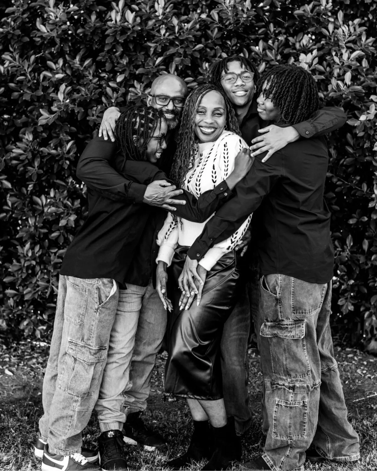 Black and white photo of a family of five in a big group hug, Gilbert family photographer