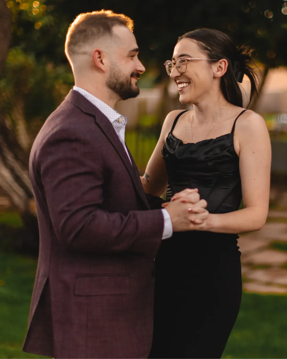 Couple laughing and dancing together at golden hour during a Gilbert AZ portrait session
