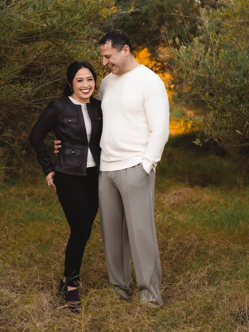 Couple laughing together at golden hour during a family portrait session near Gilbert, Arizona taken by Andria Meixner of Andria May Photography.