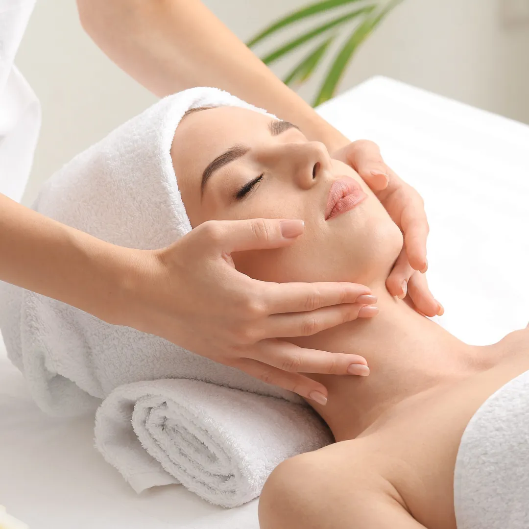 Master aesthetician applying facial treatment during a DermaCare signature service