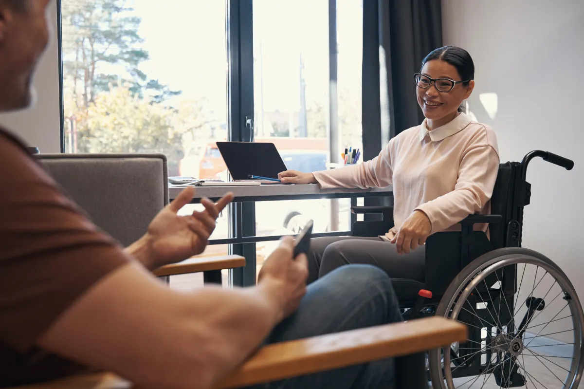 jolly-woman-with-disability-talking-with-man