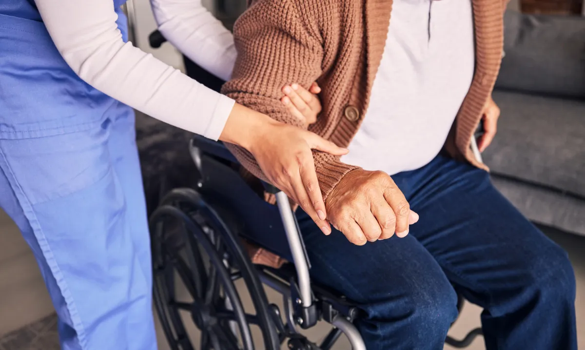 hands-nurse-and-patient-in-wheelchair-for-support