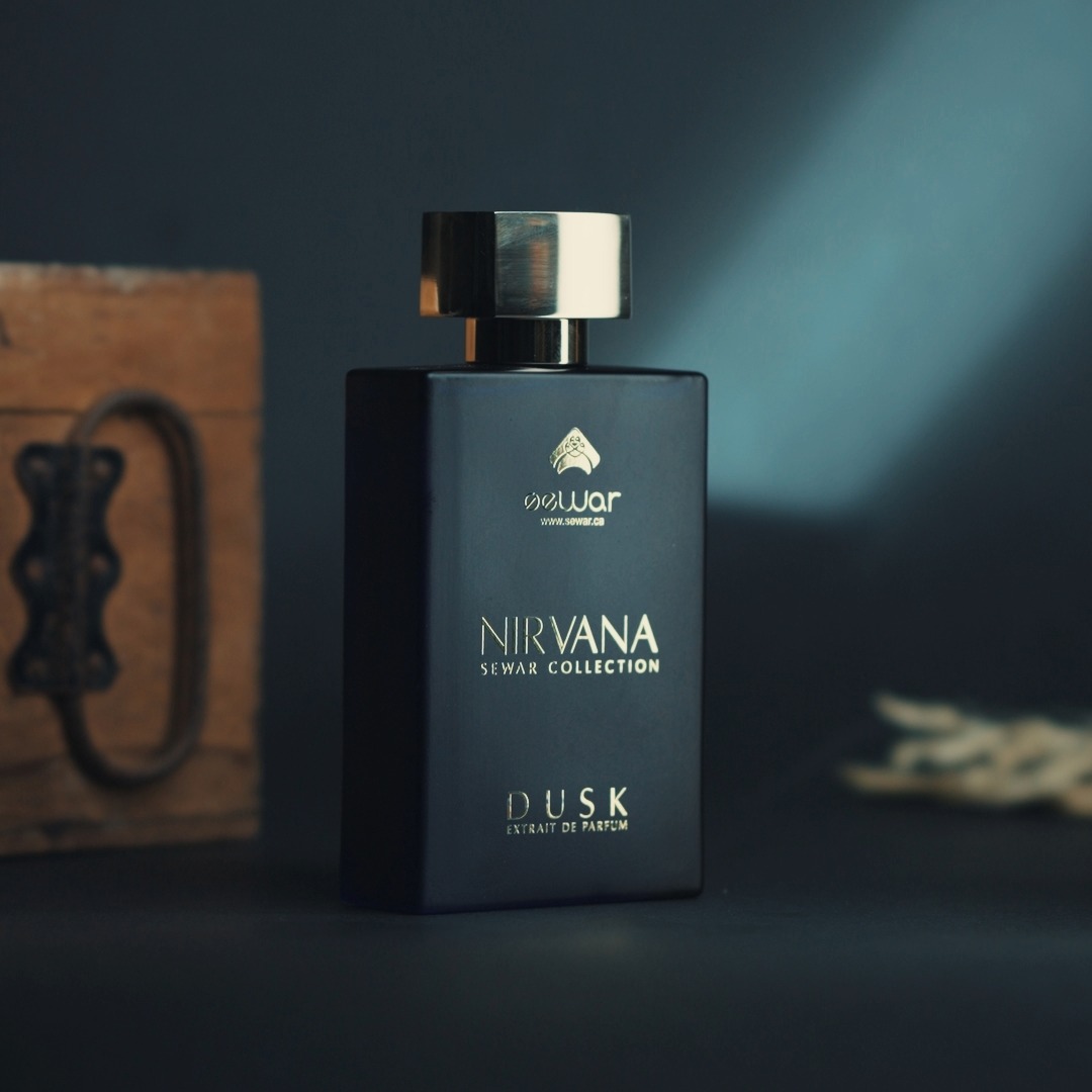 a bottle of cologne sitting on top of a blue blanket