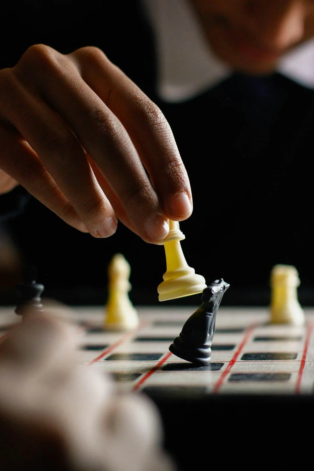 Liability risks in business shown by a chess piece being knocked over – why contractors need umbrella excess liability insurance