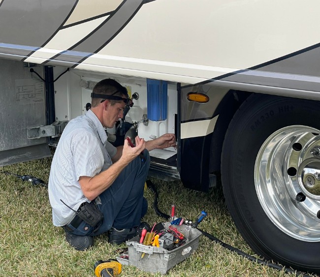 a pair of pliers laying on the ground surrounded by leaves