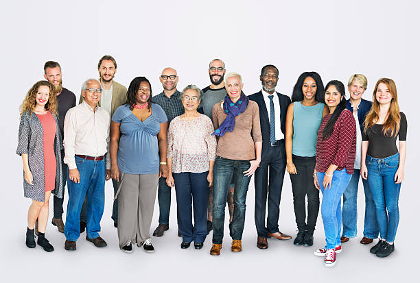 A documentary-style photo of a group of diverse adults, including a man in his 30s, a woman in her 50s, and a young athlete, gathered in a bright studio. They are discussing wellness goals, with purple and teal accents in the decor, representing inclusivity and guidance.