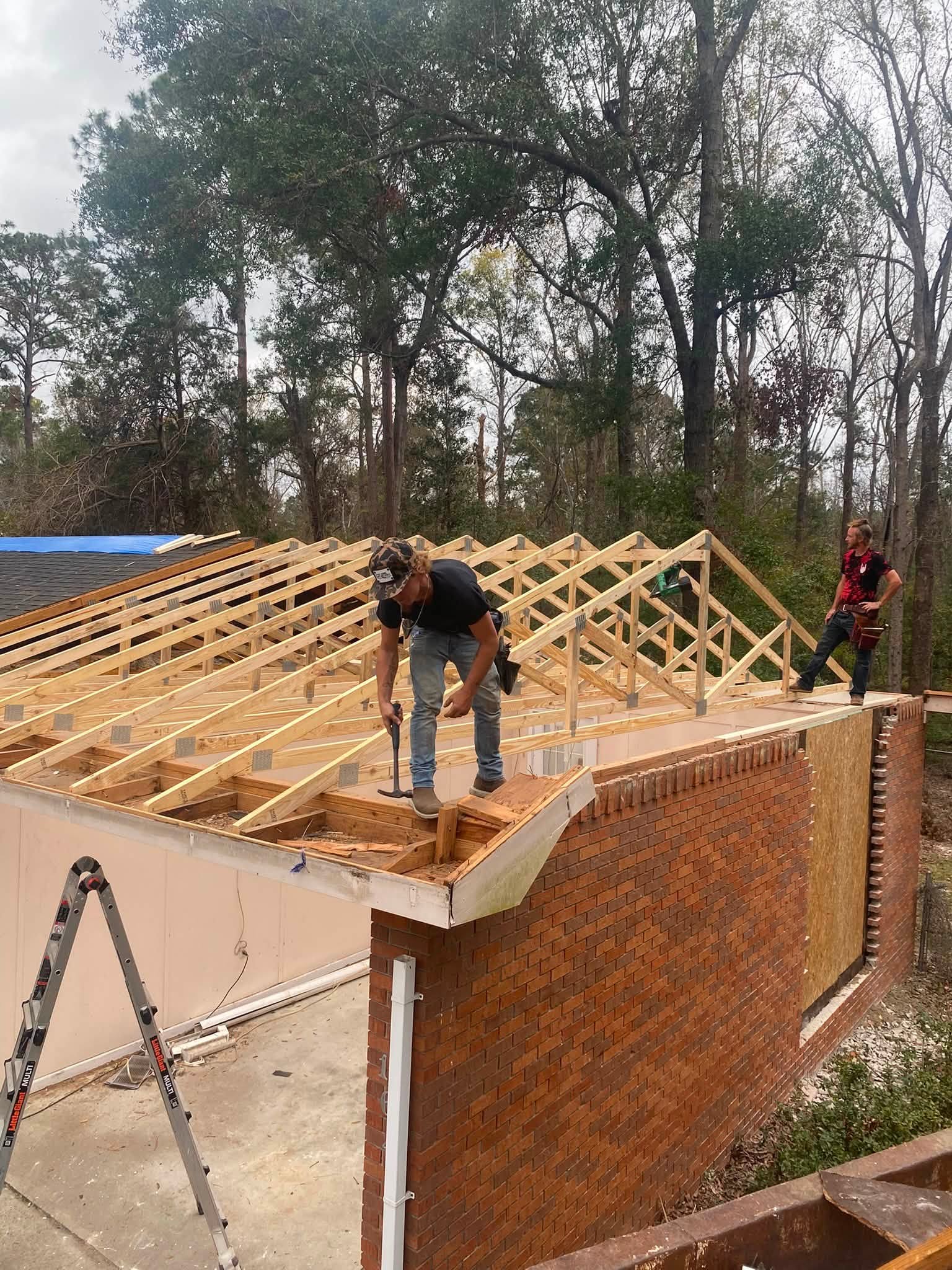 crew setting roof trusses on a barndominium frame in Tattnall County, GA