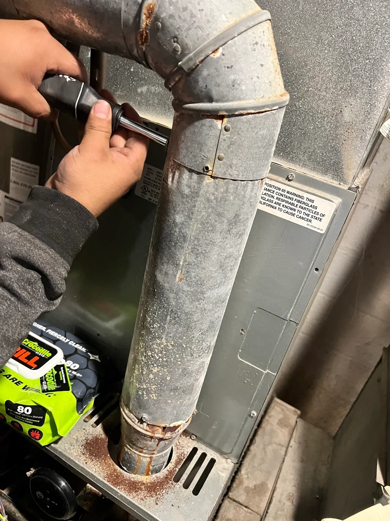 a man working on a motorcycle with a wrench