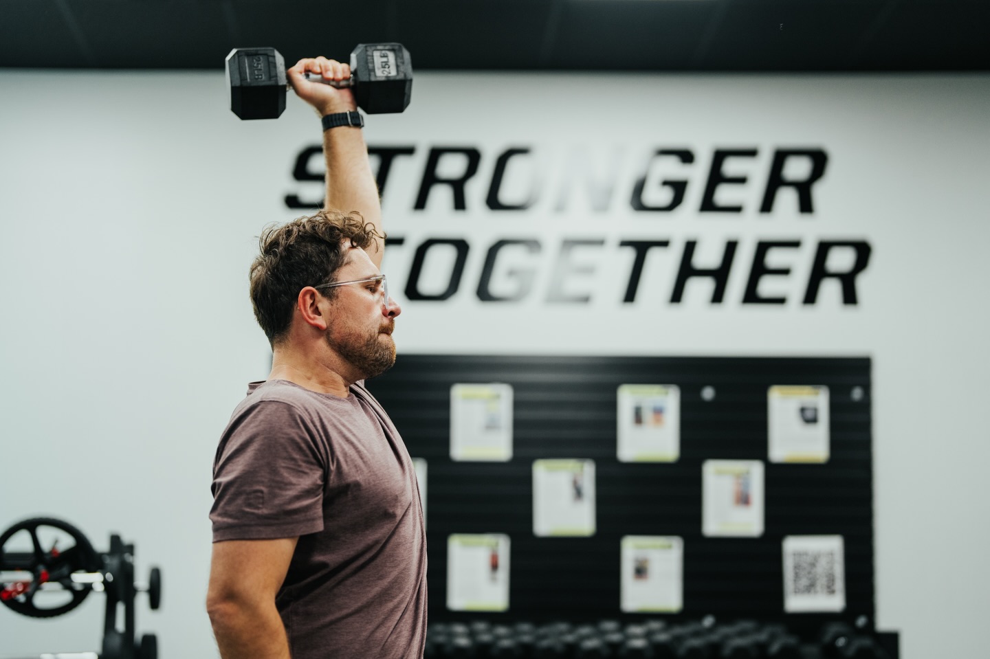 Male in 40's Lifting a Dumbell. At Alloy Personal Training Concord we don't use machines. Everything is coach led. You get a group of up to 6 people. Every fitness plan is completely customized to fit your goals and your body.